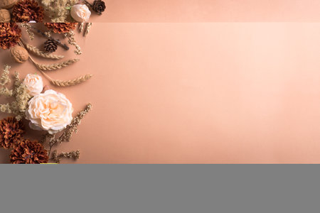 Autunm wheat, rose flowers composition on craft beige background, copy space. Stylish creative autumn fall mock up, autunm holiday celebration concept.の写真素材