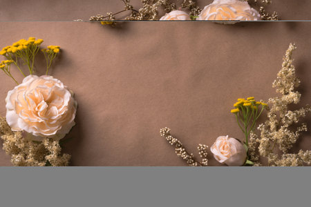 Autunm rose flowers frame on craft brown background, copy space. Stylish creative autumn fall mock up, autunm holiday celebration concept.の写真素材