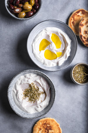 Labneh yogurt cream cheese with olive oil and zaatar close up. Traditional arabian or middle eastern homemade labneh dip. Arabic food.の写真素材