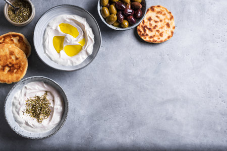 Labneh yogurt cream cheese with olive oil and zaatar, copy space. Traditional arabian or middle eastern homemade labneh dip.の写真素材