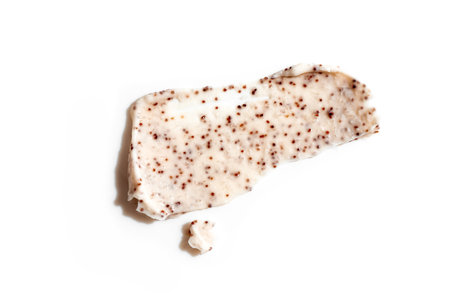 Sample of natural scrub isolated on white background. Peeling cream with microcapsules. Peach or...