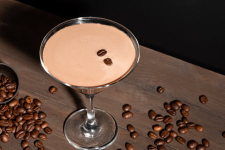 Espresso Martini cocktail with coffee beans on dark background, top view, copy space. Coffee liqueur drink.の写真素材