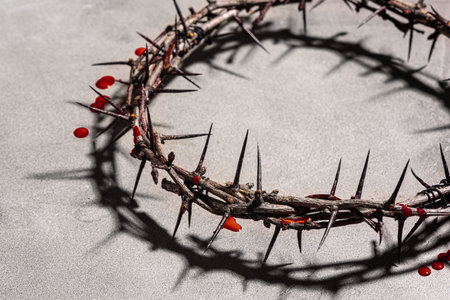 Crown of thorns with blood drops on gray stone background, side view. Christian concept of suffering. Jesus Passion week, Good Friday and Easter design.の写真素材