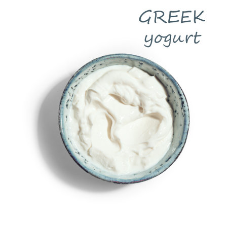 Bowl of Greek yogurt isolated on white background, top view. Sour cream or cream cheese, design element.の写真素材