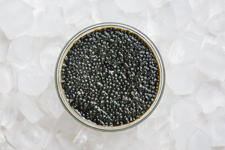 Black Sturgeon caviar in glass jar on ice, top view. Sturgeon or Beluga caviarの写真素材