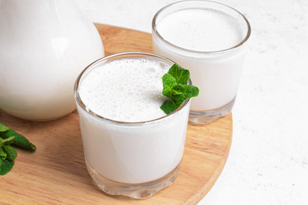 Turkish traditional drink ayran, kefir or buttermilk in glasses, homemade plain yogurt close up. Probiotic fermented drink, healthy food.の写真素材