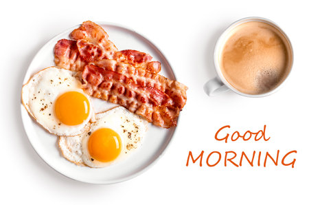 Breakfast with fried eggs and bacon isolated on white background, top view. Fried sunny side eggs with bacon on plate and cup of morning coffee.の写真素材