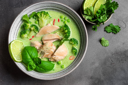 Thai green curry chicken soup on concrete background, top view, copy space. Healthy traditional meal, Thai food, Asian style lunch.の写真素材