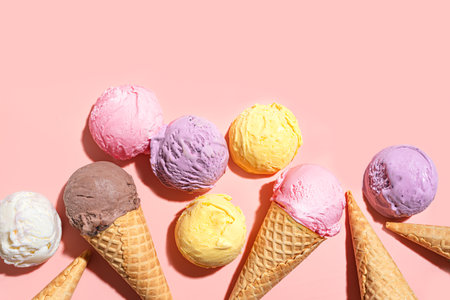 Assorted Ice Cream Scoops on pink pastel background, top view, copy space. Many organic gelato ice cream scoops and waffle cones, summer dessert concept.の写真素材