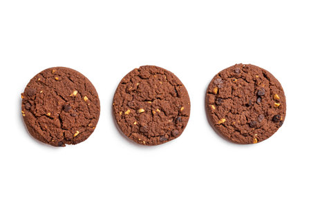 Chocolate chip cookies with hazelnuts isolated on white background, top view, design elements. Three homemade chocolate brownie cookies.の写真素材