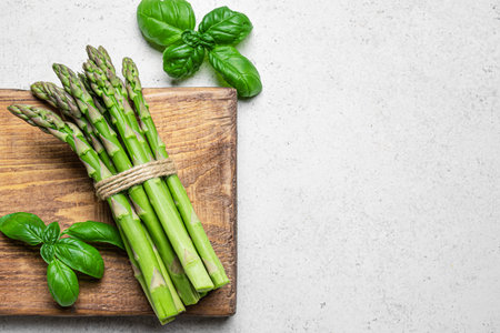Asparagus on white background, top view, copy space. Bunch of fresh green asparagus ready to cook.の写真素材