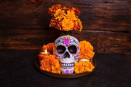 Painted skull with cempasuchil or marigold flowers and candles, altar for Mexican Dia De Los Muertos...