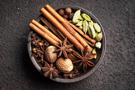 Traditional Christmas spices, extremely close up, top view. Cinnamon sticks, anise stars, cardamom,...
