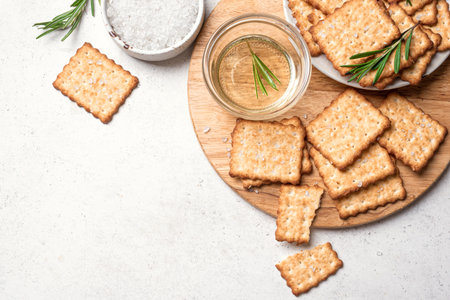 Olive oil salty crackers with rosemary, top view, copy space. Homemade cripsy crackers with sea salt...