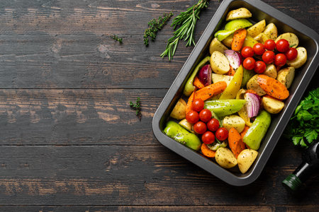 Raw seasonal vegetables on baking tray ready to cook, top view, copy space. Cooking organic vegan vegetarian meal, oven roasting vegetablesの写真素材