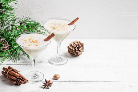 Christmas Eggnog Martini or Brandy Alexander cocktail festive drink, white background, copy space. Eggnog mocktail for Christmas and winter holidays.の写真素材