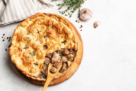 Chicken and Mushroom Pie on white background, top view, copy space. Seasonal hearty comfort meal - homemade creamy meat pie for winter weekend.の写真素材