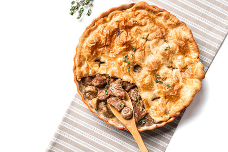 Chicken and Mushroom Pie on beige tablecloth isolated on white background, top view, design element. Seasonal homemade creamy meat pie.の写真素材