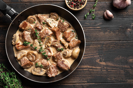 Creamy Chicken and Mushroom Stroganoff on black wooden background, top view, copy space. Delisious comfort food for autumn and winter.の写真素材