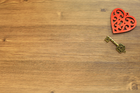 Wooden heart and keys on a wooden background. Valentines day. Love and romanticの写真素材