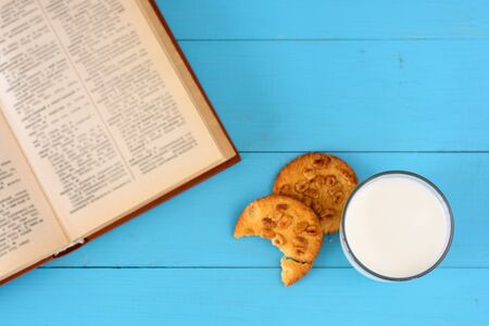 A glass of milk, homemade cakes (oatmeal cookies with nuts) and a glass of milk.の写真素材
