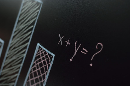 Business woman is drawing charts, plans, diagrams mathematical equation with two unknowns and...