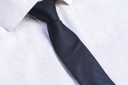 Business accessories (cufflinks, fountain pen) in the men's classic white shirt with tieの写真素材