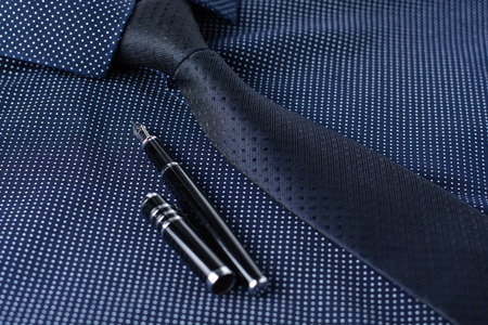 Business accessories (cufflinks, fountain pen, tablet, phone, notepad, dairy) in the men's classic shirt with tieの写真素材