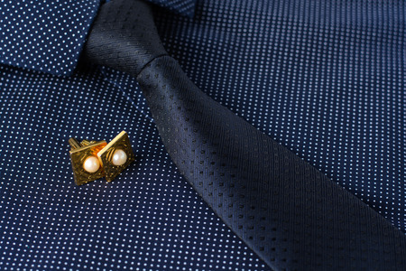 Business accessories (cufflinks, fountain pen, tablet, phone, notepad, dairy) in the men's classic shirt with tieの写真素材