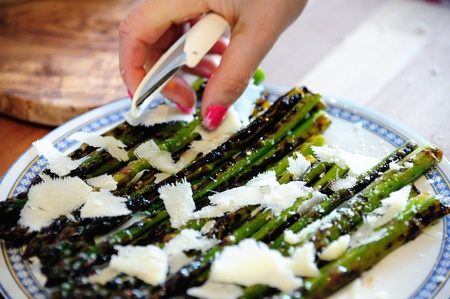 A plate of grilled asparagus with parmigiano cheeseの写真素材