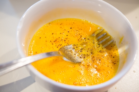 Some beaten egg with pepper ready for Spaghetti alla Carbonaraの写真素材