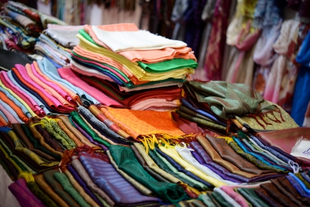 colorful dresses scarfs and shirts on the open market in a Indian marketの写真素材