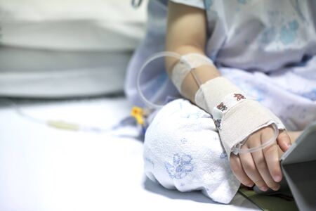 Sick child on a receiving a saline solution in hospital