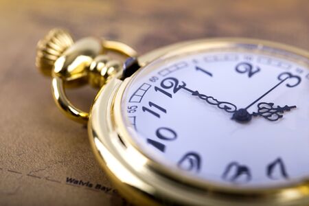 Classic Necklace gold pocket watch on retro mapの写真素材