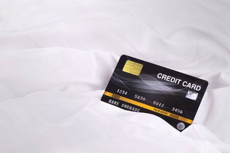 Credit card on white cloth fabric texture background ,  business shopping online payment conceptの写真素材