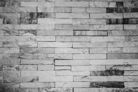 Empty white old brick wall texture. Building facade with damaged plaster.の写真素材
