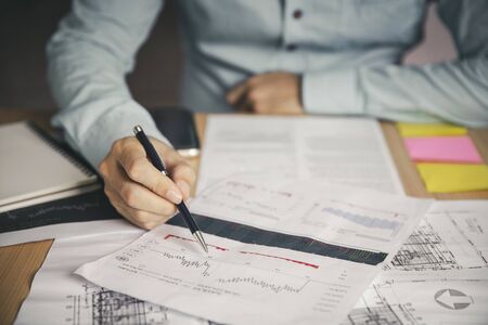 Businessman with analysis graph design Ideas and project about business growth at meeting room.の写真素材