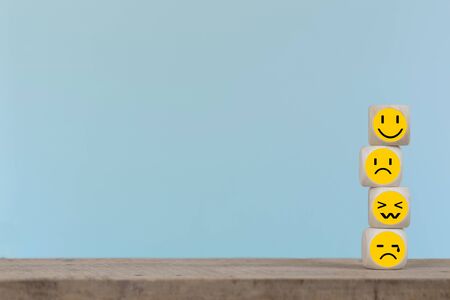 Emoticon icons face on Wooden Cube , Costumer service conceptの写真素材