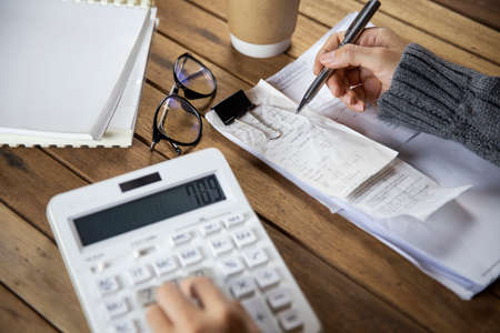 Business woman working at office with documents on his desk , Counting financial data and examines the financial resultsの写真素材