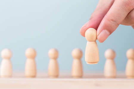 Hand holding chooses a leadership to success business , Concept is the leadership and team victory in business.の写真素材