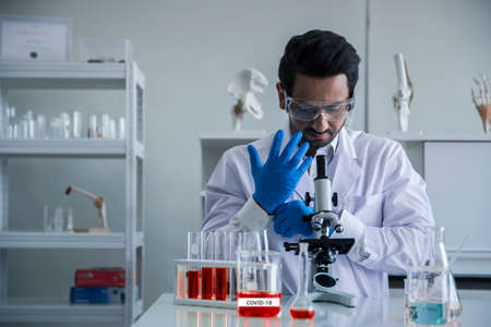 Attractive scientist medical worker with sample test tube at laboratory , doing a analysis in a...