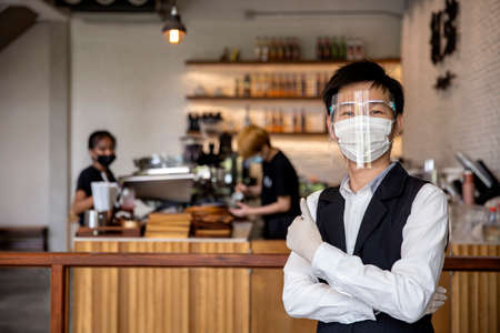 Coffee and restaurant shop owner expressed confidence in preventing , or the , by wearing a face mask and gloves. concept protectの写真素材