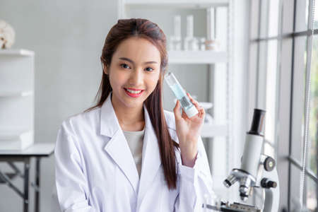 Attractive young asian scientist woman chemical sample in flask at laboratory , Asia medical woman...