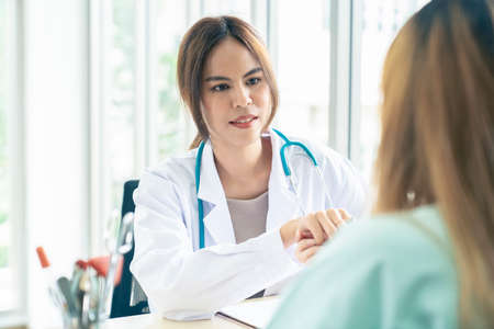 Smiling Asian woman pediatrician give advice to patients , Young asia female doctor consult female...