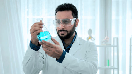 Scientist of laboratory researcher holding medical glass bottle. Analysing Chemicals in Laboratory with test tubes. Scientist looking at flask for analysis medical for chemistry developmentの写真素材