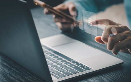 Businessman using computer laptop on e document on digital tablet , E-signing on e document and virtual notepad on virtual screen , electronic signature , paperless office conceptの写真素材