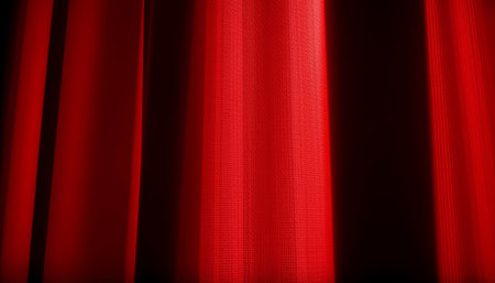 A red fabric curtain glowing with soft light, creating warm and dramatic atmosphere with visible texture and foldsの素材