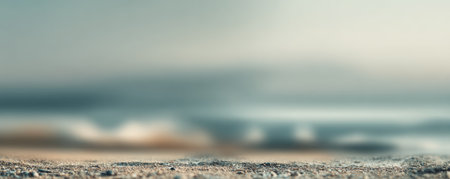 Soft pebbled beach foreground with shallow depth of field and soft blue ocean bokeh creating calm serene moodの素材