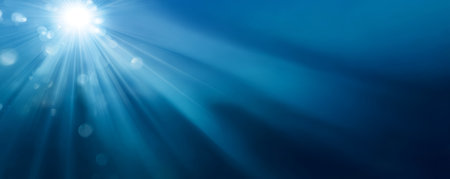Sunlight rays underwater with blue bokeh and serene glow creating peaceful moodの素材