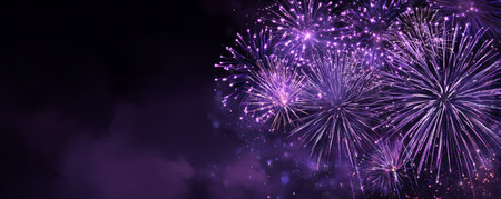 Purple fireworks burst over night sky creating festive sparkle and smoky atmosphere with celebratory energy and glowing particlesの素材